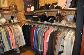 One of the two packed closets filled with woman's clothing and accessories
