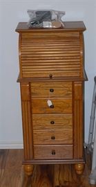 jewelry chest with lift top, roll top section and opening side panels. Oak.