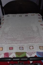 A marvel of the art of tatting! This tatted bed coverlet or table cloth features the Lord's Prayer with angels above and to the sides, surrounded by multiple colors of flowers. Fits a full size bed as shown, if used as a coverlet. Wonderful condition - one stain at upper left. No attempt has been made to clean it, so even that may come out with the right touch. 