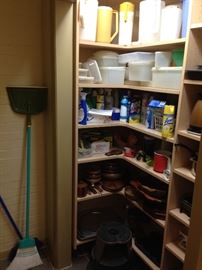 Wooden items, trays, Tupperware, cleaning supplies, a well-stocked pantry