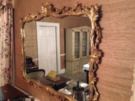 Huge oak leaf and acorn motif mirror in dining room. Be prepared to have help taking this down and carrying it out.