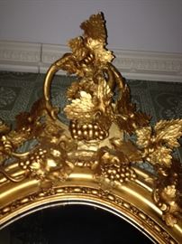 Crown of gilded mirror in stairs