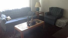 Living room couch, chair, footstool, oak glass wood tables, lamps, leather liquor bottles from Italy