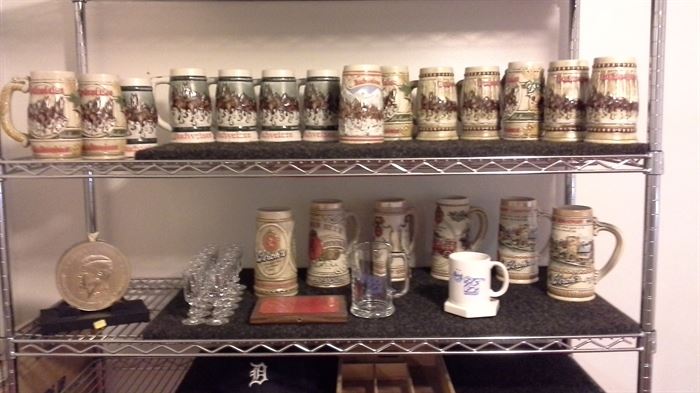 Stroh's numbered collectible mugs, Budweiser Series mugs, glass vases, case of glass liquor pony sryle glasses, wire rack on wheels