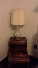 Antique wood table, brass hardware and wheeled feet, leather top.  Frosted glass silk shade lamps.  Both are 1 of 2