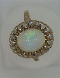 Opal ring surrounded with rose cut diamonds, marked 10 Ct