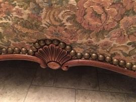 Details: shell carving and brass tack trim