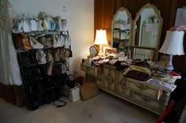 Racks of wonderful purses and bags.  French Provincial long dresser with mirror