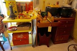 Yellow rolling utility cart (with electrical power) and note the tin bread bin at bottom
