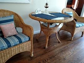 Wicker table and two chairs, table approximately 40 inches round