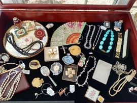 Costume jewelry including a White Diamonds by Elizabeth Taylor ladies watch, turquoise necklace, vintage compacts, etc.