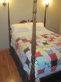 Queen size 4 poster bed with bedding.