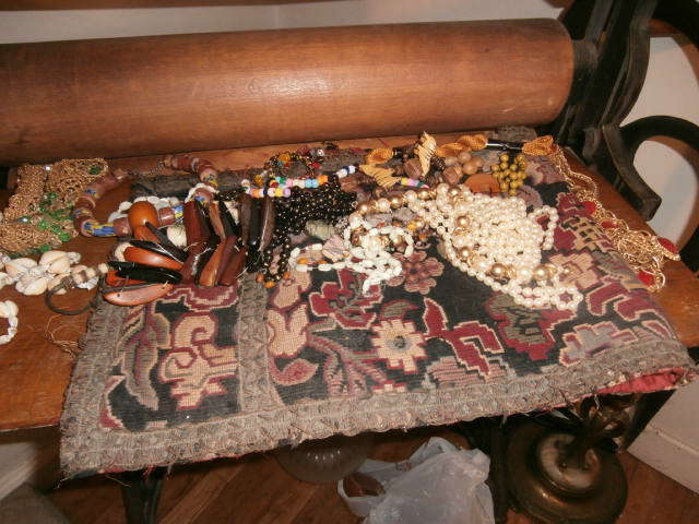 Costume jewelry on a prayer rug on the antique printing press.  (Jewelry will be in case on day of sale.)