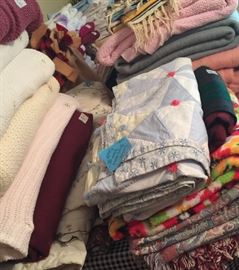Lots of blankets, quilts, bedspreads