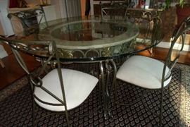 very nice round dining table w/4 chairs & glass top, rug is also for sale