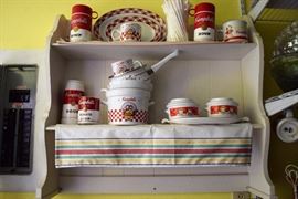 White shelf, linen and Campbell's Soup memorabilia for sale.