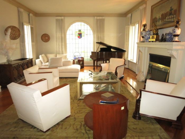Set of 3 Art Deco Chairs from Anne Hauk, Pair of White Deco Chairs from Lief; Pair of Deco-Style Side Tables by Ralph Lauren, all on a 14 foot Silk & Wool Carpet.  Behr Brothers Baby Grand.  Cambell Glass Silvered Mirrored Coffee Table.  Mantle Urns are Royal Dux.