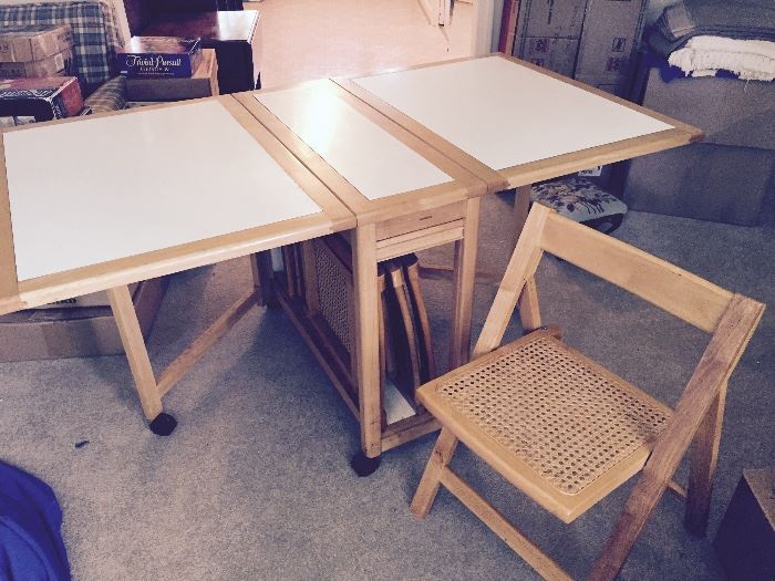 Drop leaf table with four chairs (stored in the middle storage area)