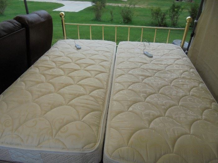 Dual Sleep number 4000 mattresses make for a King Size bed each with their own frame, box spring, air pump and remote. Great condition with brass headboard. Will include mattress covers.
