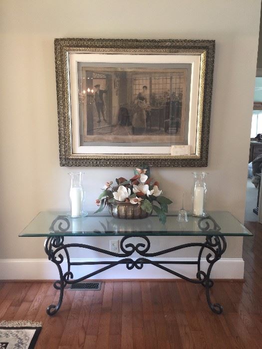 Glass topped wrought iron table in the foyer, antique engraving not for sale.
