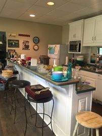 Bar stools, bar ware, and kitchen items as well as the refrigerator and microwave!