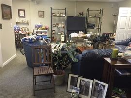 A great blue leather sofa, love seat, and club chair and ottoman. Also, a mission style sofa table and vintage chair. Note all the golf decor!