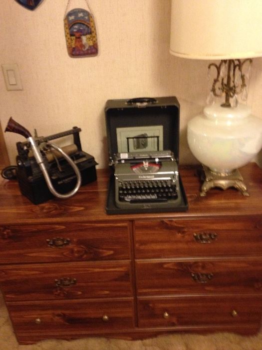 Dresser with vintage lamp, a Dictaphone machine and an Underwood typewriter.