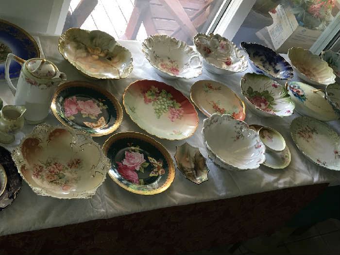 Multiple hand painted antique plates and bowls in a wide variety of subjects. Includes pieces marked Bavarian.
