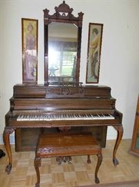 Lovely working Piano with hinged Bench .  Antique ornate wall mirror