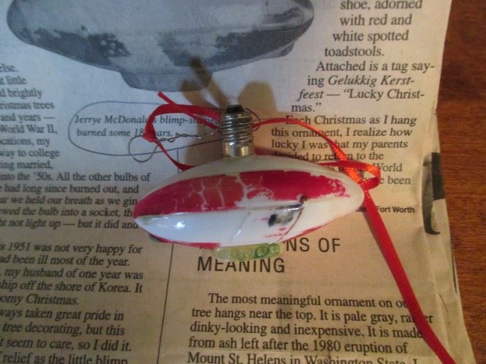 antique Blimp Christmas light bulb made into an ornament with accompanying article from the Ft Worth Star Telegram