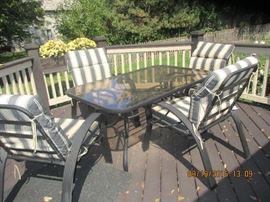 Patio table and four chairs with cushions