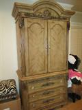 Light colored Honey Armoire houses flat screen tv.