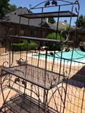 One of two metal etageres or bakers racks suitable just about anywhere. You can spray paint your special color; these are bronze