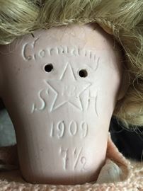 Markings on the back of the doll