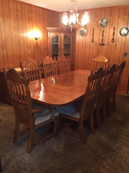 Solid oak dining table with eight chairs, excellent condition