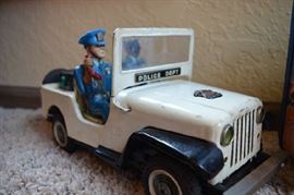 Metal Police Car - one policeman's face is missing