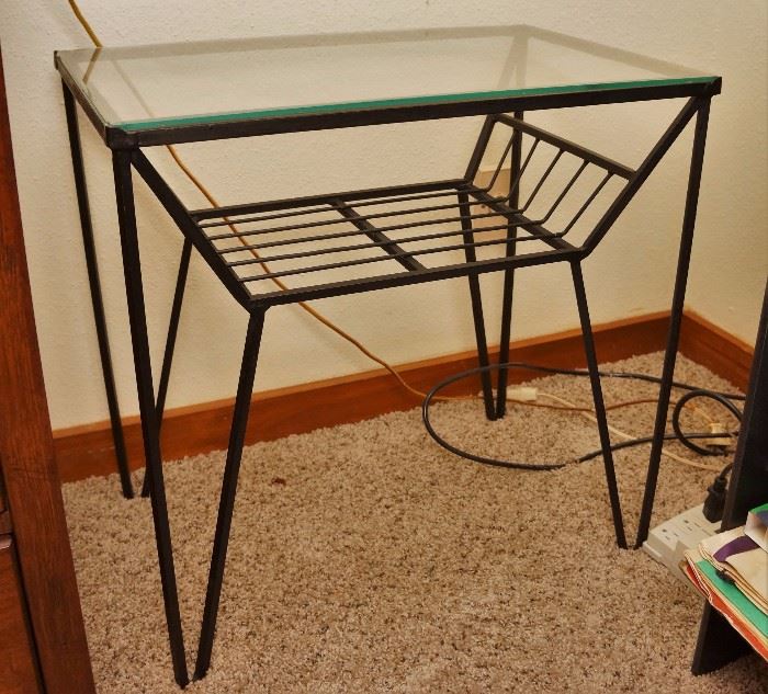 One of several vintage metal and glass tables