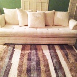 96" long white sofa ($550.00), 64"x100" rug ($50.00)