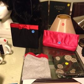 black purse with red stripe ($5.00, red purse ($3.00) . 6/9 month baby cloth ($2.00), green silk scarf with pattern ($5.00). lamp shade ($1.00).