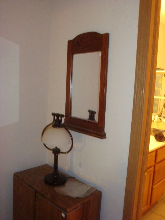 Mirror and another lamp on small cabinet