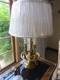 Brass Table Lamp with three Candlestick Stems supported by Dolphins over a Socle
