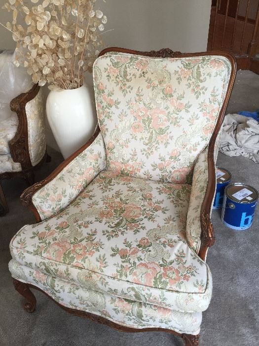 Beautiful vintage upholstered chair with carved arms and legs.
