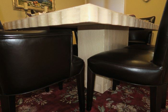 From Sherwood Studio in West Bloomfield.  Solid Travertine Stone Table With 6 Black Leather Chairs (4 side chairs & 2 arm chairs) table measures approximately 80'' L x 42'' W x 30'' H