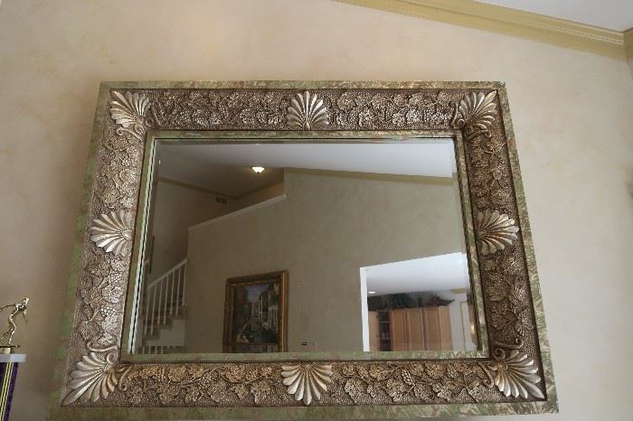 Beautiful Beveled Framed Mirror with tones of bronze Silver Leaf and Gold Leaf.  Measures approximately 49 1/2'' W x 38'' H x 4 1/2'' D