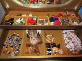 THERE IS A LARGE ASSORTMENT OF JEWELRY