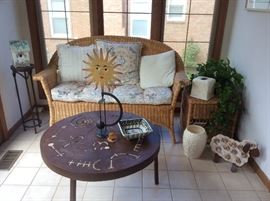 Wicker porch settee, metal coffee table with cutout details