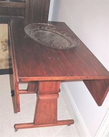 Unusual table adjusts to regular table height or coffee table height.