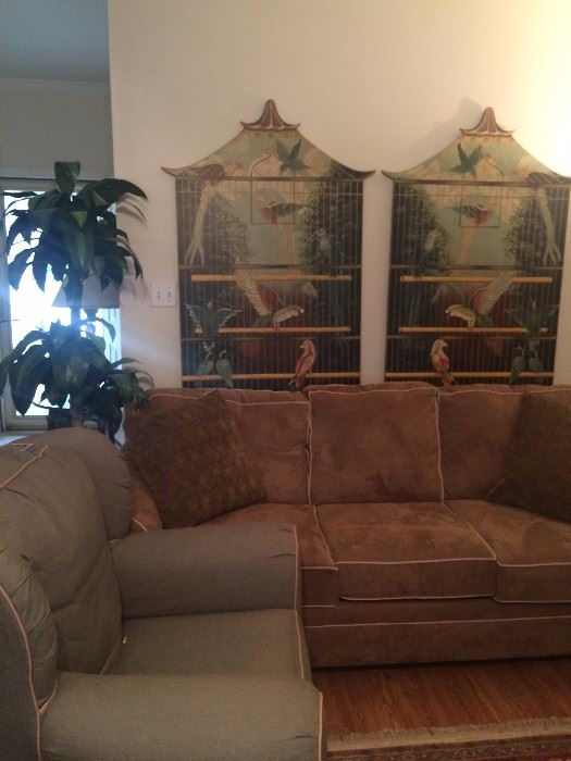 Light brown sofa with coordinating pale green chair; two tropical bird cage panels