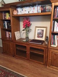 TV/bookcase wall units; variety of books including cookbooks