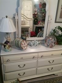 Six drawer dresser with mirror; ceramic monkey; decorative plates